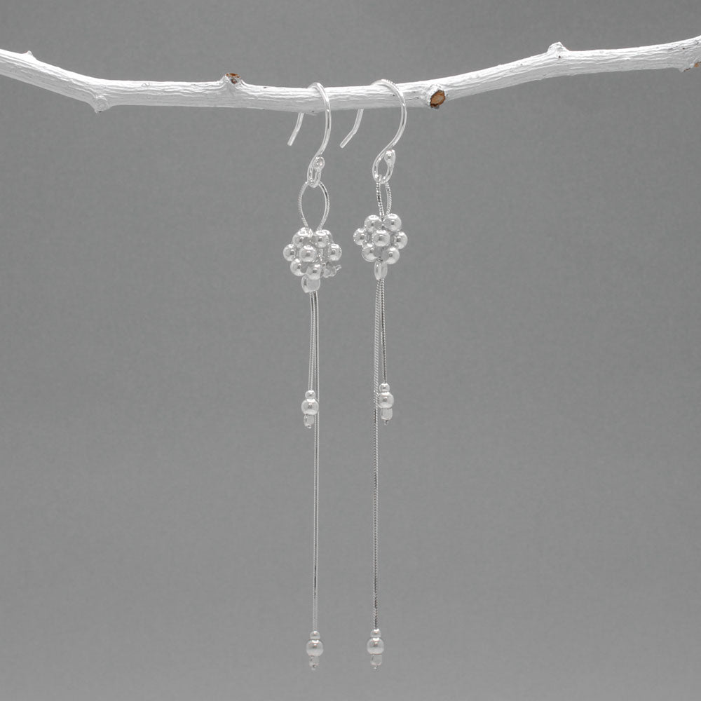 The Áine – Beaded Cluster Double Chain Silver Dangle Earrings feature a delicate arrangement of silver beads in a clustered design, suspended from double fine chains for graceful movement. Crafted in solid .925 sterling silver, these lightweight earrings are a beautiful mix of texture and flow, perfect for day-to-evening wear.