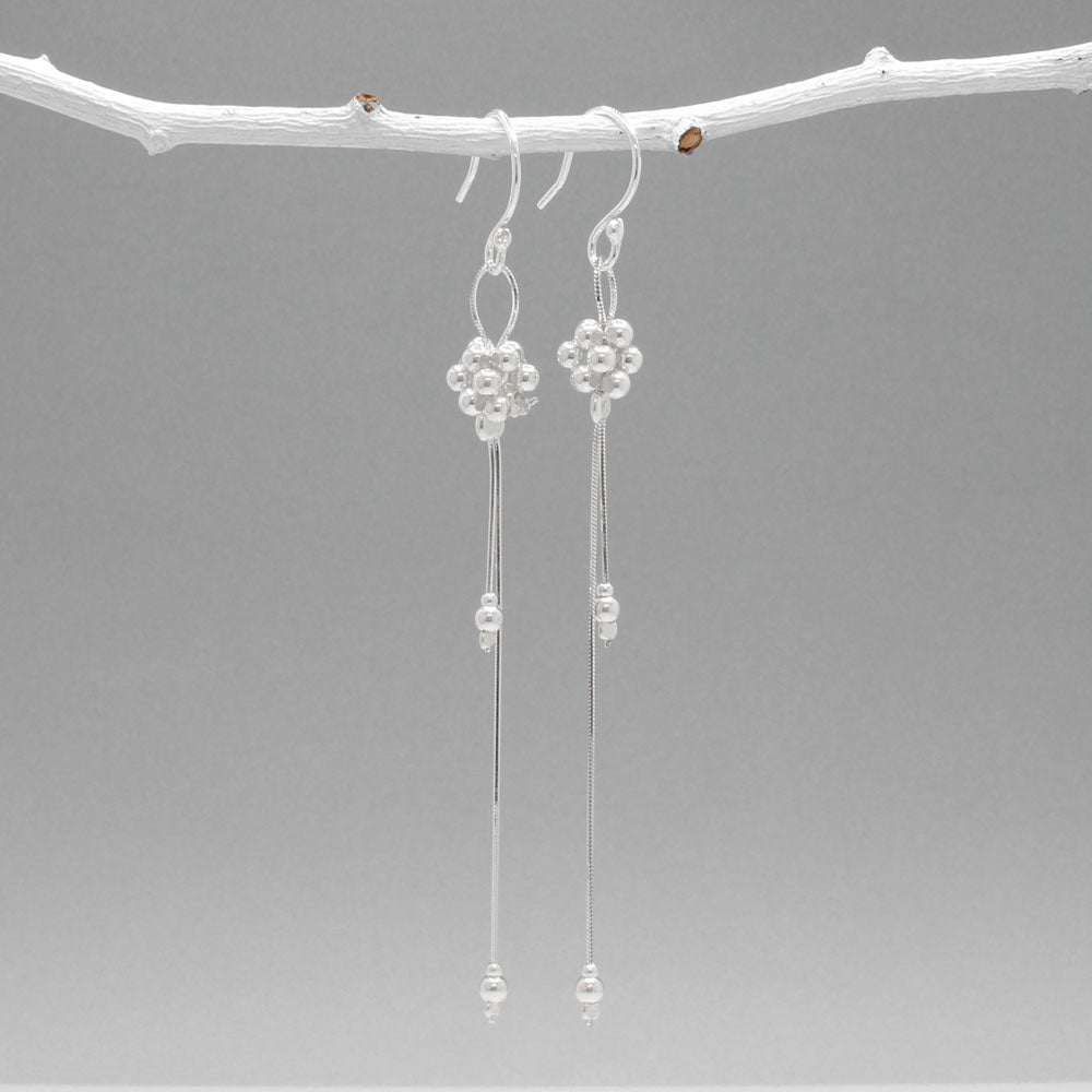 The Áine – Beaded Cluster Double Chain Silver Dangle Earrings feature a delicate arrangement of silver beads in a clustered design, suspended from double fine chains for graceful movement. Crafted in solid .925 sterling silver, these lightweight earrings are a beautiful mix of texture and flow, perfect for day-to-evening wear.