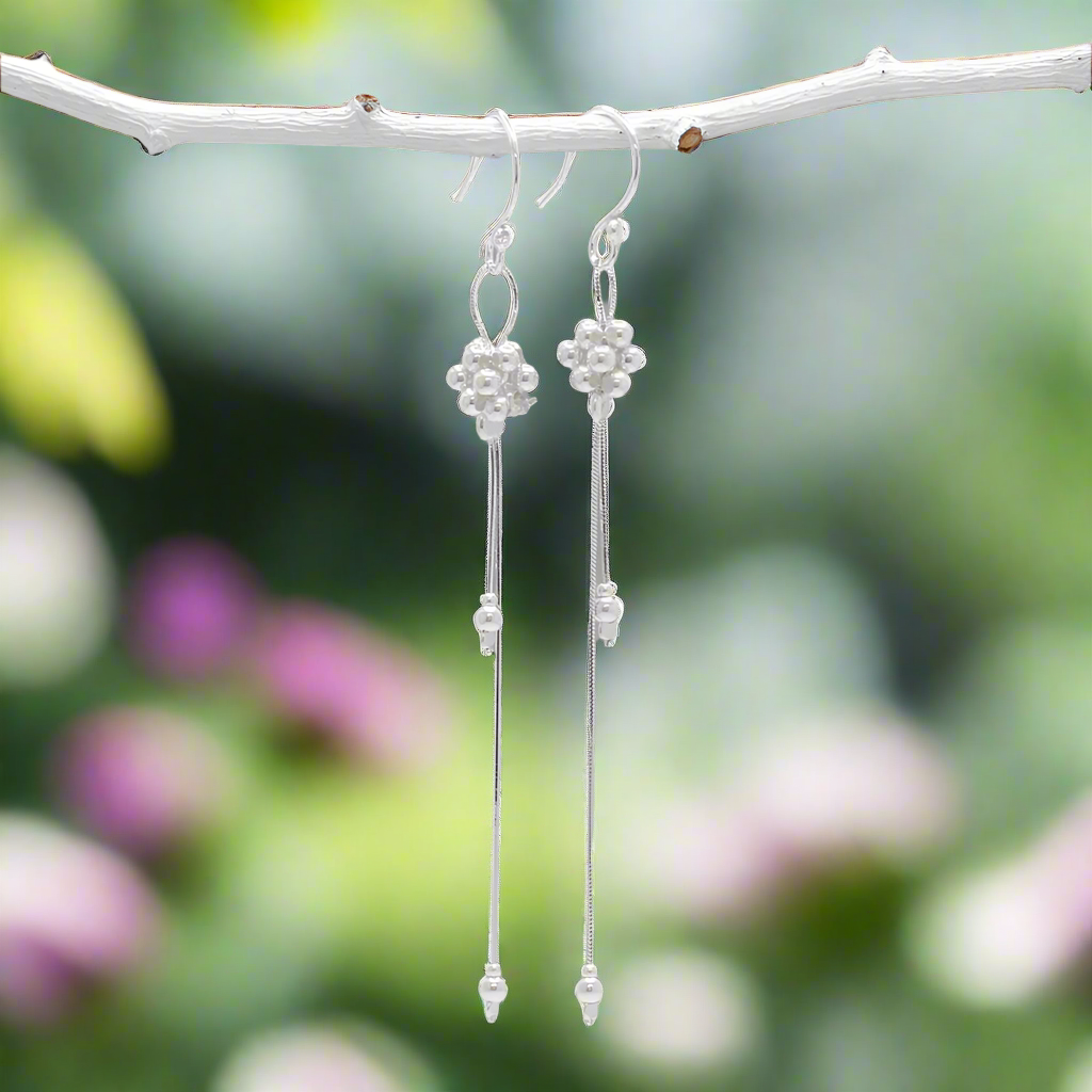 The Áine – Beaded Cluster Double Chain Silver Dangle Earrings feature a delicate arrangement of silver beads in a clustered design, suspended from double fine chains for graceful movement. Crafted in solid .925 sterling silver, these lightweight earrings are a beautiful mix of texture and flow, perfect for day-to-evening wear.