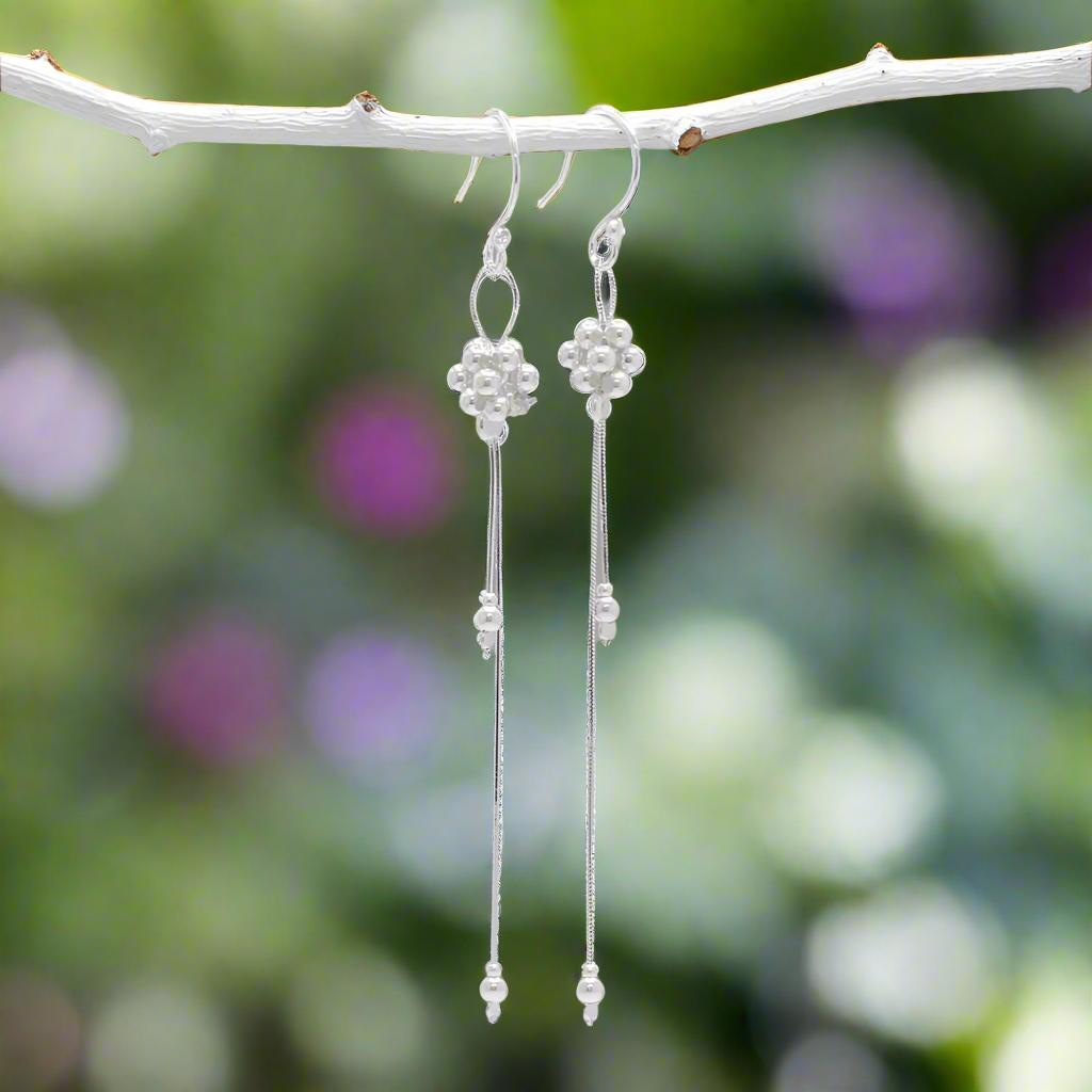 The Áine – Beaded Cluster Double Chain Silver Dangle Earrings feature a delicate arrangement of silver beads in a clustered design, suspended from double fine chains for graceful movement. Crafted in solid .925 sterling silver, these lightweight earrings are a beautiful mix of texture and flow, perfect for day-to-evening wear.