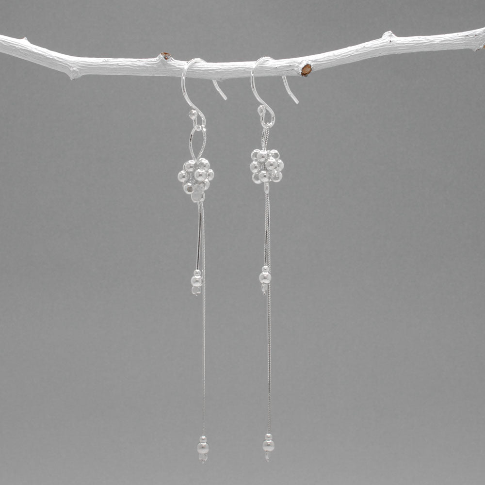 The Áine – Beaded Cluster Double Chain Silver Dangle Earrings feature a delicate arrangement of silver beads in a clustered design, suspended from double fine chains for graceful movement. Crafted in solid .925 sterling silver, these lightweight earrings are a beautiful mix of texture and flow, perfect for day-to-evening wear.