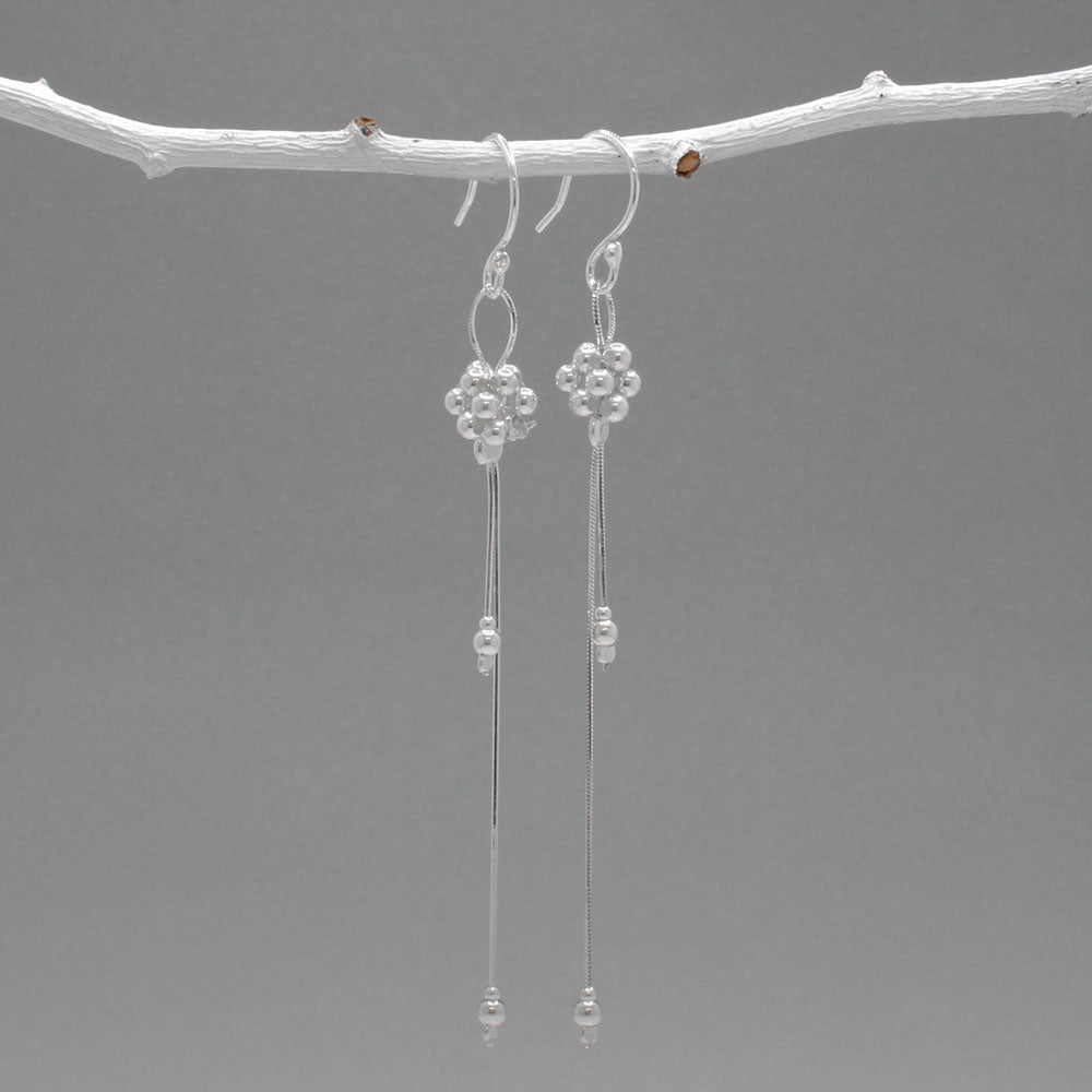 The Áine – Beaded Cluster Double Chain Silver Dangle Earrings feature a delicate arrangement of silver beads in a clustered design, suspended from double fine chains for graceful movement. Crafted in solid .925 sterling silver, these lightweight earrings are a beautiful mix of texture and flow, perfect for day-to-evening wear.
