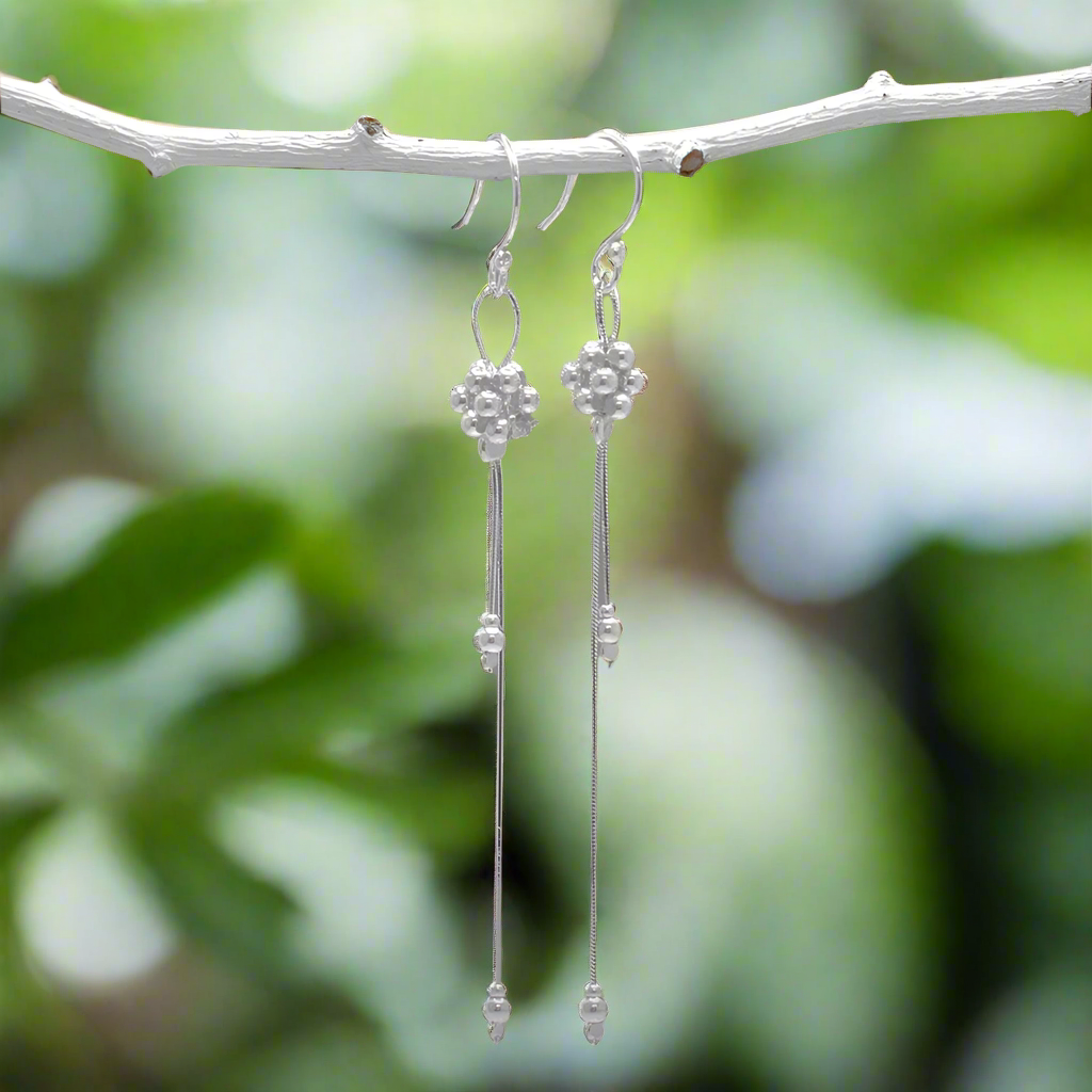 The Áine – Beaded Cluster Double Chain Silver Dangle Earrings feature a delicate arrangement of silver beads in a clustered design, suspended from double fine chains for graceful movement. Crafted in solid .925 sterling silver, these lightweight earrings are a beautiful mix of texture and flow, perfect for day-to-evening wear.