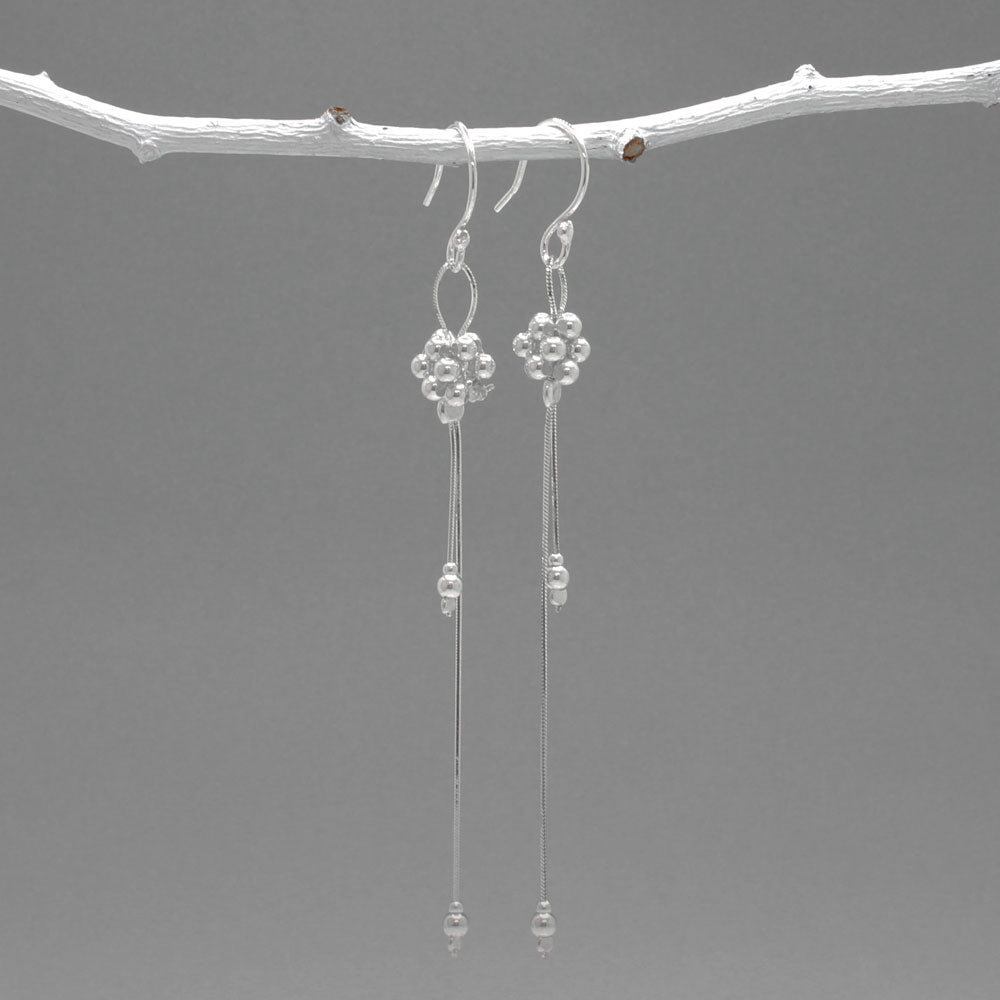 The Áine – Beaded Cluster Double Chain Silver Dangle Earrings feature a delicate arrangement of silver beads in a clustered design, suspended from double fine chains for graceful movement. Crafted in solid .925 sterling silver, these lightweight earrings are a beautiful mix of texture and flow, perfect for day-to-evening wear.