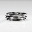Aran - Lasso S Oxidised Silver Ring. Inspired by lasso rope designs, this piece offers a unique twist to your style. Crafted with oxidized sterling silver and featuring a comfortable 6mm band width, it's perfect for wearing solo or stacking with other rings to make a statement.
