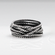 Aran - Twisted Lasso Oxidised Silver Ring. Inspired by the intricate twists of lasso rope designs, this piece adds a unique flair to your style. Crafted from oxidized sterling silver and featuring a comfortable 7mm band width, it's ideal for wearing alone or stacking with other rings for a bold statement. 
