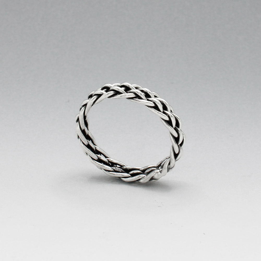 Aran - Thread Weave Oxidised Silver Ring A unisex piece designed to seamlessly blend style and substance. This ring measures 5mm wide and 3mm thick, crafted from solid oxidised sterling silver. Made with .925 sterling silver, the Aran ring offers both durability and timeless elegance. Its versatile design makes it a perfect accessory for any occasion, suitable for both men and women.