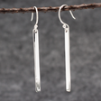 Artemis Slab Earrings: handcrafted elegance! Picture sterling silver gracefully dangling, adding timeless beauty to any look. These sleek earrings measure 40mm long by 3mm wide (approx. 1 & 5/8 inches long by 1/8 inches wide). Crafted from .950 sterling silver with a high-polished finish, they're wearable art. With secure dangle French wires, they offer comfort all day. 