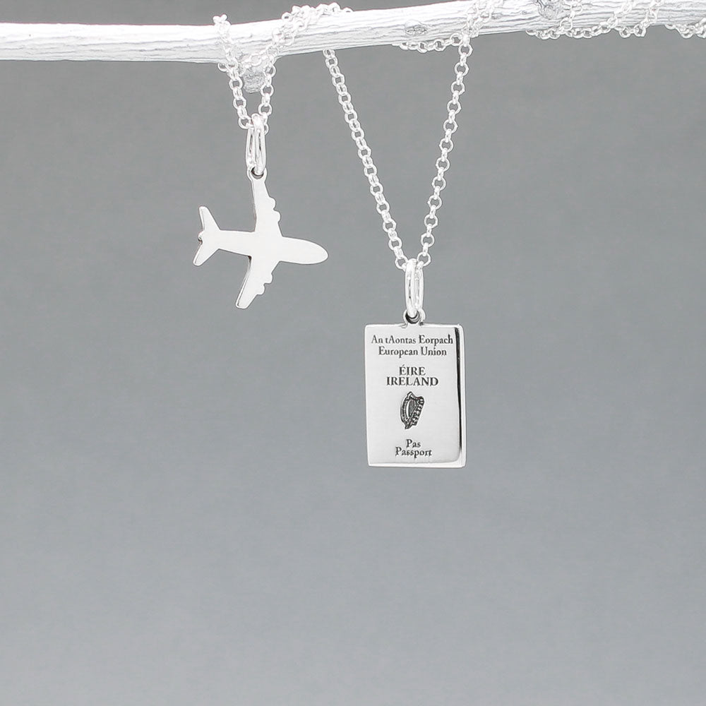 Our Irish Passport Mini Replica Silver Pendant captures all the intricate details of an Irish passport cover. Meticulously crafted from sterling silver, it boasts a dazzling high-polished finish. 🇮🇪✈️ Dimensions: Passport: 10mm wide by 14mm high Airplane: 14mm wide by 14mm high Bail: Fits up to a 2.5mm chain for versatile wear. Chain: Includes a 1.4mm sterling silver belcher Rolo chain, available in various lengths to suit your style preference.