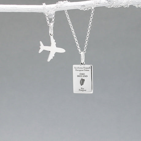 Our Irish Passport Mini Replica Silver Pendant captures all the intricate details of an Irish passport cover. Meticulously crafted from sterling silver, it boasts a dazzling high-polished finish. 🇮🇪✈️ Dimensions: Passport: 10mm wide by 14mm high Airplane: 14mm wide by 14mm high Bail: Fits up to a 2.5mm chain for versatile wear. Chain: Includes a 1.4mm sterling silver belcher Rolo chain, available in various lengths to suit your style preference.