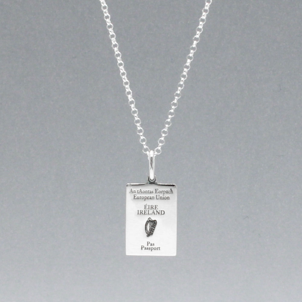 Our Irish Passport Mini Replica Silver Pendant captures all the intricate details of an Irish passport cover. Meticulously crafted from sterling silver, it boasts a dazzling high-polished finish. 🇮🇪✈️ Dimensions: Passport: 10mm wide by 14mm high Airplane: 14mm wide by 14mm high Bail: Fits up to a 2.5mm chain for versatile wear. Chain: Includes a 1.4mm sterling silver belcher Rolo chain, available in various lengths to suit your style preference.