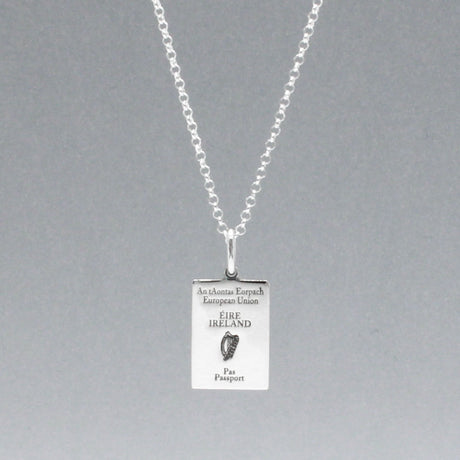 Our Irish Passport Mini Replica Silver Pendant captures all the intricate details of an Irish passport cover. Meticulously crafted from sterling silver, it boasts a dazzling high-polished finish. 🇮🇪✈️  Dimensions: Passport: 10mm wide by 14mm high Airplane: 14mm wide by 14mm high Bail: Fits up to a 2.5mm chain for versatile wear. Chain: Includes a 1.4mm sterling silver belcher Rolo chain, available in various lengths to suit your style preference.