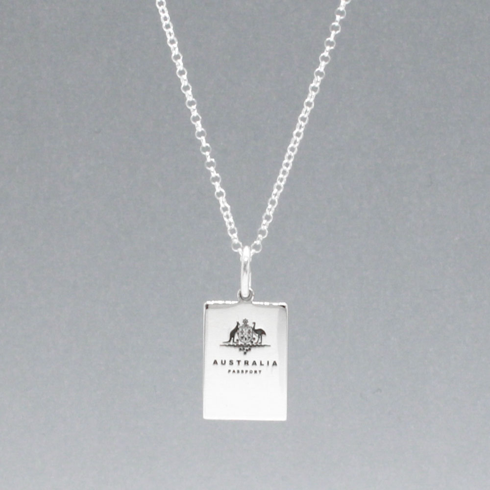 Our Australian Passport Mini Replica Silver Pendant captures all the intricate details of a passport cover. Meticulously crafted from sterling silver, it boasts a dazzling high-polished finish. Dimensions: Passport: 10mm wide by 14mm high Airplane: 14mm wide by 14mm high Bail: Fits up to a 2.5mm chain for versatile wear. Chain: Includes a 1.4mm sterling silver belcher Rolo chain, available in various lengths to suit your style preference.