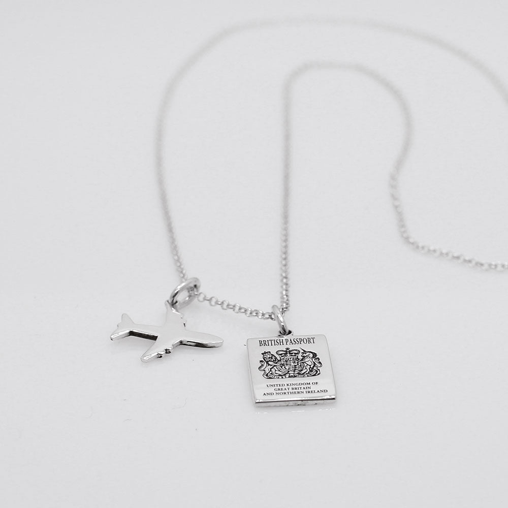 Our British Passport Mini Replica Silver Pendant captures all the intricate details of a British passport cover. Meticulously crafted from sterling silver, it boasts a dazzling high-polished finish. Dimensions: Passport: 10mm wide by 14mm high Airplane: 14mm wide by 14mm high Bail: Fits up to a 2.5mm chain for versatile wear. Chain: Includes a 1.4mm sterling silver belcher Rolo chain, available in various lengths to suit your style preference.