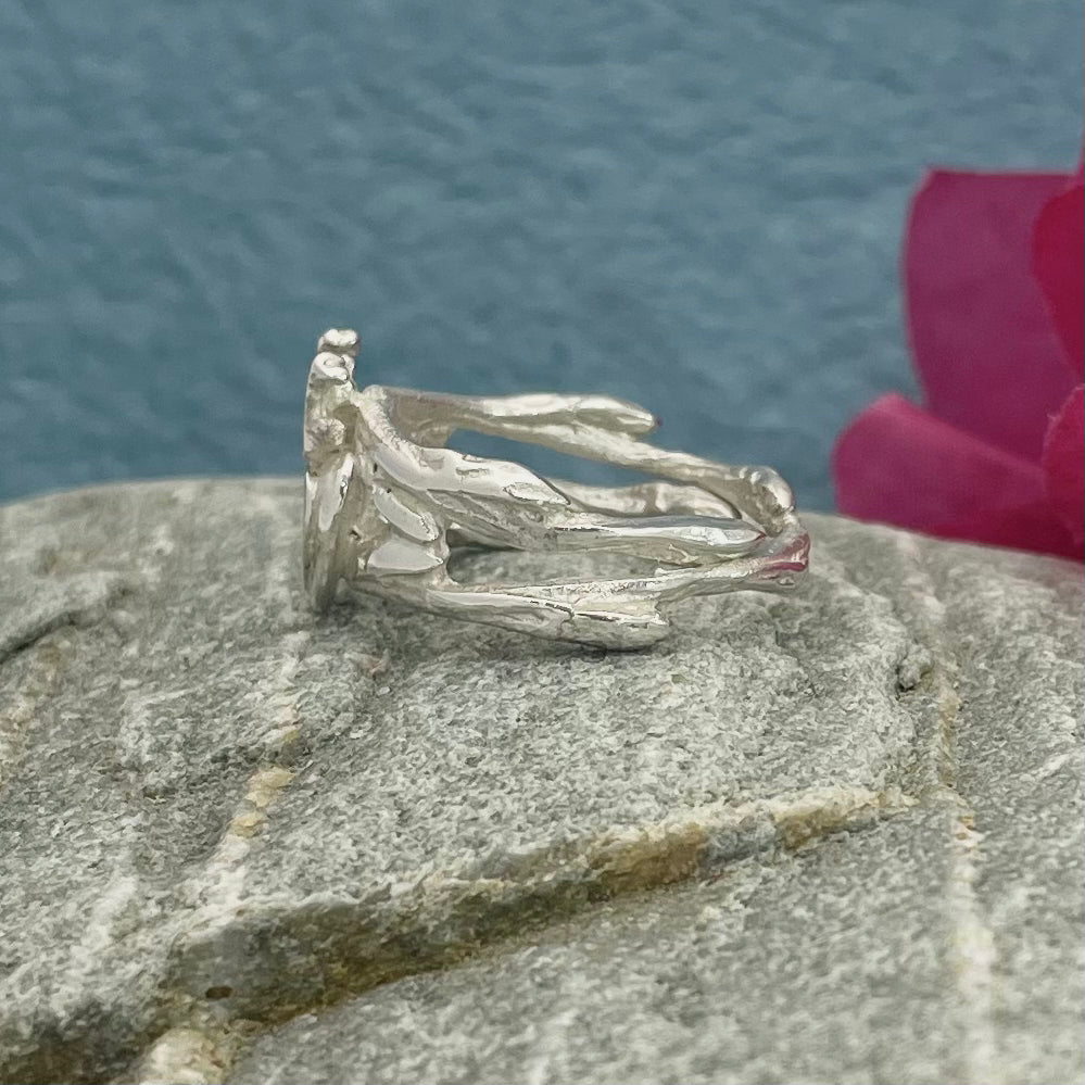 Double Claddagh Silver Ring with a Touch of Pink Tourmaline Design: Organic Claddagh inspired by twigs and Irish coral Material: Solid sterling silver cast Finish: Highly polished Band: 7.5mm in width Centre: Heart and crown measure 13mm long Accent: 1mm pink tourmaline A beautifully crafted piece that blends tradition with nature’s elegance. Perfect for expressing love, loyalty, and friendship.