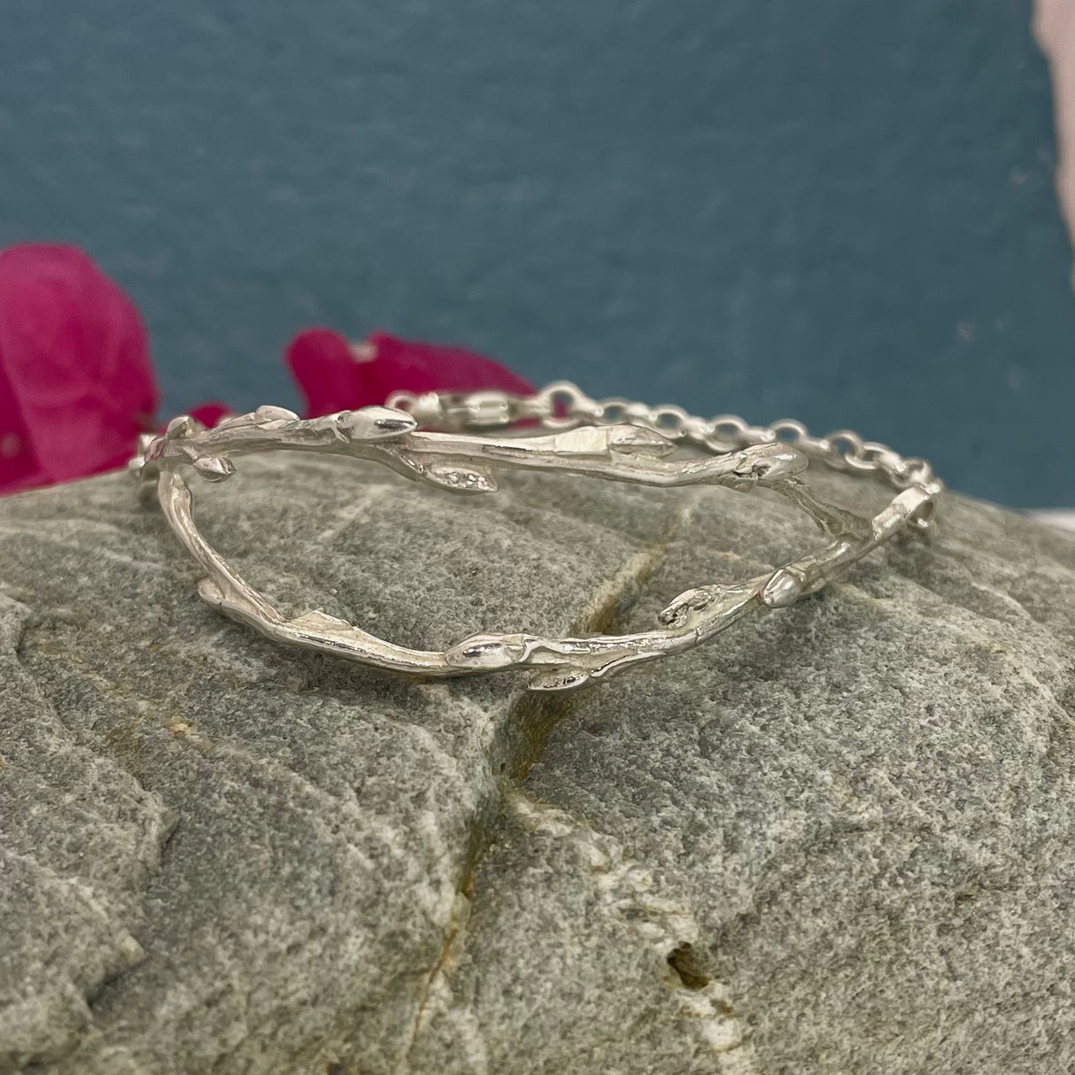 Double Twig with Chain Silver Bracelet Width: 20mm at its widest point Twigs: Each measures 5mm at its widest point, sterling silver cast with a highly polished finish Chain: 3.5mm silver chain with a lobster clasp Length: Select your preferred bracelet length below Kathleen Holland Jewellery