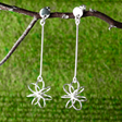Moineir Floating Flower Silver Earrings - Studs: where whimsy meets elegance in stunning craftsmanship. Handcrafted from .925 sterling silver, these earrings feature a charming 14mm flower on a slim 36mm stem, they strike a perfect balance between subtlety and statement. With a secure friction back, they're comfortable for day-to-night wear. 