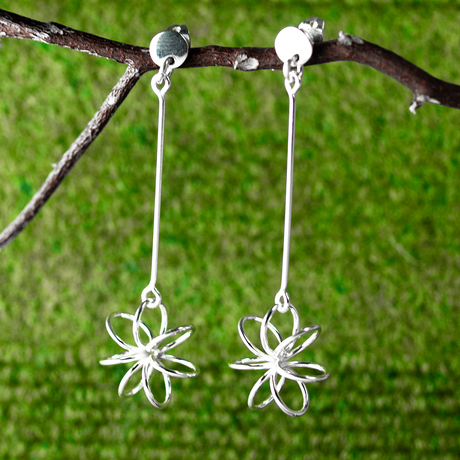 Moineir Floating Flower Silver Earrings - Studs: where whimsy meets elegance in stunning craftsmanship. Handcrafted from .925 sterling silver, these earrings feature a charming 14mm flower on a slim 36mm stem, they strike a perfect balance between subtlety and statement. With a secure friction back, they're comfortable for day-to-night wear. 