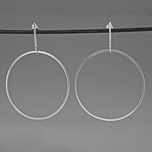 Saha - RADA G Silver Earrings - Stud. These earrings boast impressive dimensions, measuring 50mm in diameter by 1.5mm thick, or roughly 1 1/16 inches diameter by 1/16 inches thick. From the top of the ear wire, they extend elegantly at 70mm, equivalent to 2 7/8 inches.