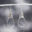 The Saha Drop Shape with Wire Wrap Silver Earrings bring timeless elegance to your jewellery collection. Handcrafted from sterling silver, these earrings feature a graceful drop shape accentuated with intricate wire wrapping. The highly polished finish adds a refined touch, making them ideal for both everyday wear and special occasions. Ireland jewellery