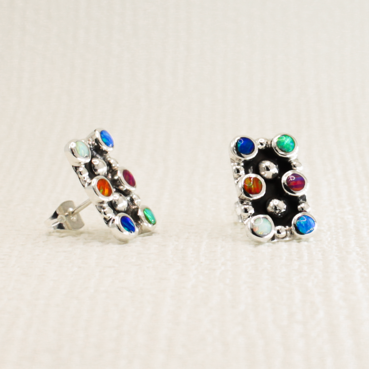 These stylish Rectangle With Round Multi-Coloured Opalescence Mosaic Resin Silver Earrings measure 10mm in width and 16mm long and feature stunning opalescent multi-coloured resins to help you sparkle with the beauty of Kinsale's colourful homes. Crafted with .925 sterling silver, the friction post will keep the earrings secure!
