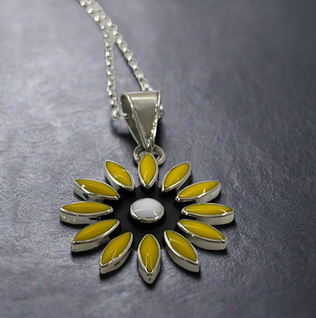 Sleveen - Daisy Flower with Yellow Resin Silver Pendant Ireland Jewellery. A striking and vibrant piece, the Sleveen Daisy Flower with Yellow Resin Silver Pendant is perfect for adding a splash of colour to your jewellery collection. Inspired by the colourful houses of Kinsale, this pendant features a bold square design with beautiful mosaic resin inlays that capture the town's vibrant charm.