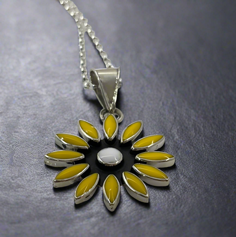 Sleveen - Daisy Flower with Yellow Resin Silver Pendant Ireland Jewellery. A striking and vibrant piece, the Sleveen Daisy Flower with Yellow Resin Silver Pendant is perfect for adding a splash of colour to your jewellery collection. Inspired by the colourful houses of Kinsale, this pendant features a bold square design with beautiful mosaic resin inlays that capture the town's vibrant charm.