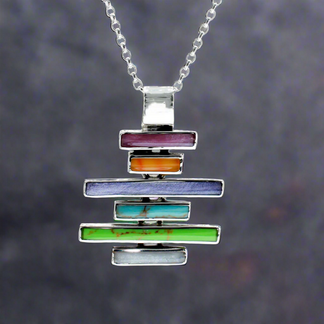Sleveen Kinsale Steps Multi-Coloured Mosaic Resin Silver Pendant. Add a vibrant splash of Kinsale’s iconic charm to your look with the Sleveen - Kinsale Steps Multi-Coloured Mosaic Resin Silver Pendant. This stunning piece draws inspiration from the colourful seaside houses of Kinsale, beautifully captured in a mosaic design. Handcrafted from .925 sterling silver, it offers both style and quality, making it the perfect standout accessory.