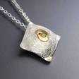 Celebrate Celtic heritage with a modern twist in this Celtic Spiral Pendant by renowned Irish designer Garrett Mallon. Inspired by one of the oldest Celtic symbols, believed to represent the sun or ethereal energy, this piece combines 18 carat gold vermeil and sterling silver, showcasing Garrett's signature style of blending textures and metals. Perfect for everyday wear! Croí Kinsale Jewellery