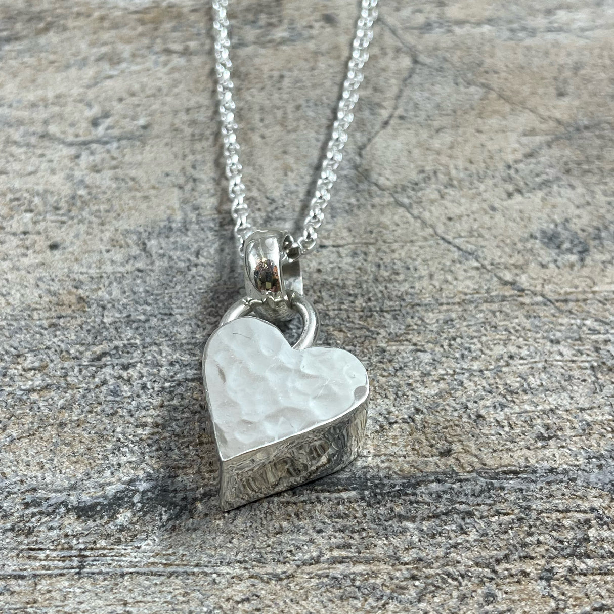 Croi - Hammered 3D Heart Silver Pendant Curated and designed by Emilio Sotelo Jewelry for Croi Kinsale Jewellery in Kinsale West Cork Ireland Europe. Find exceptional handmade silver and gold jewellery at affordable prices for birthday gifts and Christmas presents. Find Irish designers and makers. Beautiful jewellery shop located in Kinsale, Co. Cork.