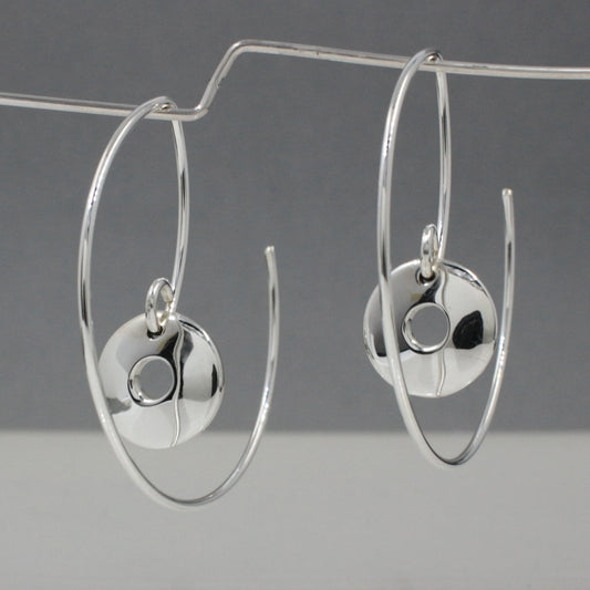 Artemis - Small Off-Center Disc Reverse Hoop Silver Earrings Curated and designed by Emilio Sotelo Jewelry for Croi Kinsale Jewellery in Kinsale West Cork Ireland Europe. Find exceptional handmade silver and gold jewellery at affordable prices for birthday gifts and Christmas presents. Handcrafted Silver jewelry. The best affordable jewellery