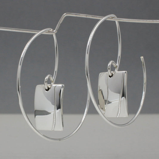 Artemis - Rectangle Silver Earrings Reverse Hoop Silver Earrings Curated and designed by Emilio Sotelo Jewelry for Croi Kinsale Jewellery in Kinsale West Cork Ireland Europe. Find exceptional handmade silver and gold jewellery at affordable prices for birthday gifts and Christmas presents. Handcrafted Silver jewelry. The best affordable jewellery