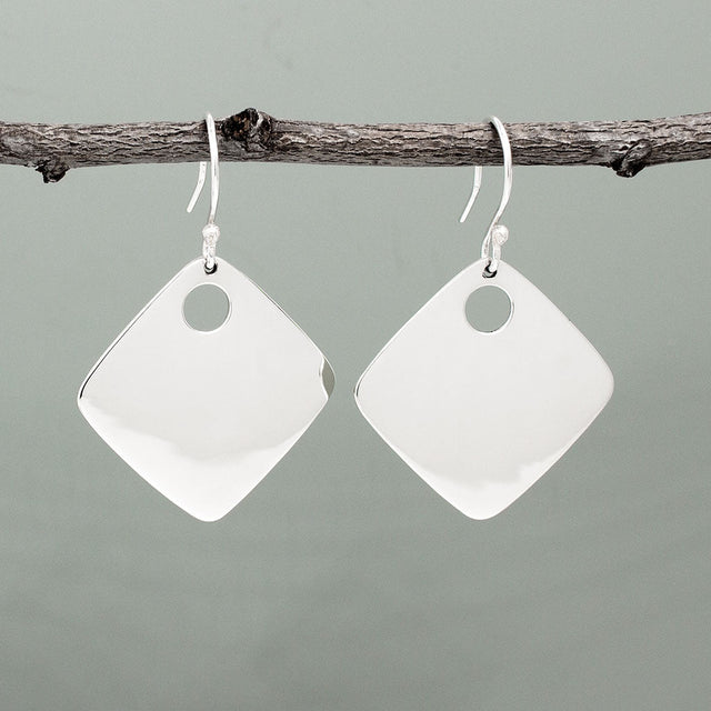 Nathalia - Rhombus Off-Center Dot Silver Earrings. With dimensions of 29mm long by 29mm wide, or roughly 1 1/4 inches square, they make a bold yet elegant statement. The off-center dot design adds a unique flair to their high polished finish.