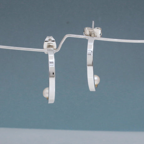 Artemis - Small Half Hoop Pearl Silver Earrings - Stud Curated and designed by Emilio Sotelo Jewelry for Croi Kinsale Jewellery in Kinsale West Cork Ireland Europe. Find exceptional handmade silver and gold jewellery at affordable prices for birthday gifts and Christmas presents. Handcrafted Silver jewelry. Find the best affordable jewellery