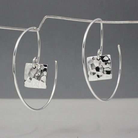 Artemis - Small Square Hammered Reverse Hoop Silver Earrings Curated and designed by Emilio Sotelo Jewelry for Croi Kinsale Jewellery in Kinsale West Cork Ireland Europe. Find exceptional handmade silver and gold jewellery at affordable prices for birthday gifts and Christmas presents. Handcrafted Silver jewelry. The best affordable jewellery