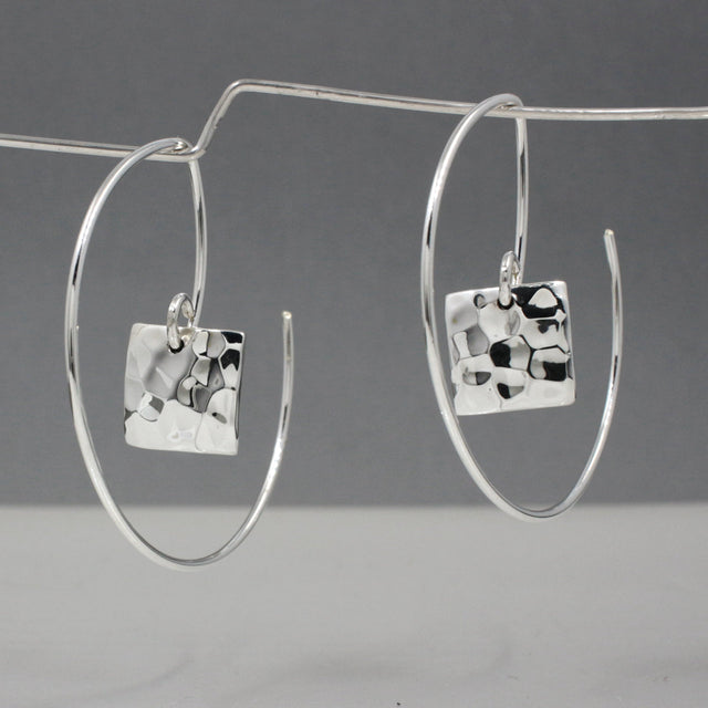 Artemis - Small Square Hammered Reverse Hoop Silver Earrings Curated and designed by Emilio Sotelo Jewelry for Croi Kinsale Jewellery in Kinsale West Cork Ireland Europe. Find exceptional handmade silver and gold jewellery at affordable prices for birthday gifts and Christmas presents. Handcrafted Silver jewelry. The best affordable jewellery