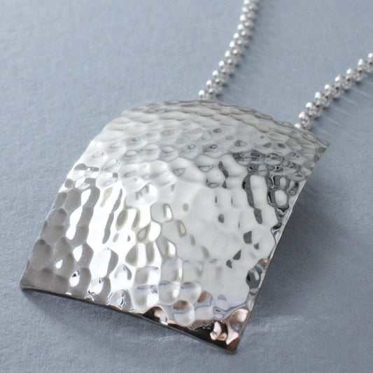 Artemis - Rectangle Hammered Silver Pendant Curated and designed by Emilio Sotelo Jewelry for Croi Kinsale Jewellery in Kinsale West Cork Ireland Europe. Find exceptional handmade silver and gold jewellery at affordable prices for birthday gifts and Christmas presents. Find Irish designers and makers. Beautiful jewellery shop located in Kinsale, Co. Cork.