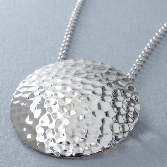 Artemis - Disc Hammered Silver Pendant Curated and designed by Emilio Sotelo Jewelry for Croi Kinsale Jewellery in Kinsale West Cork Ireland Europe. Find exceptional handmade silver and gold jewellery at affordable prices for birthday gifts and Christmas presents. Find Irish designers and makers. Beautiful jewellery shop located in Kinsale, Co. Cork.