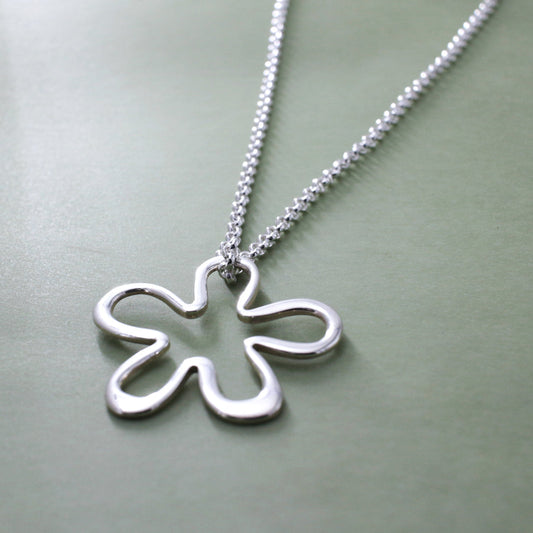 Moineir - Daisy Silhouette Silver Pendant Curated and designed by Emilio Sotelo Jewelry for Croi Kinsale Jewellery in Kinsale West Cork Ireland Europe. Find exceptional handmade silver and gold jewellery at affordable prices for birthday gifts and Christmas presents. Find Irish designers and makers. Beautiful jewellery shop located in Kinsale, Co. Cork.
