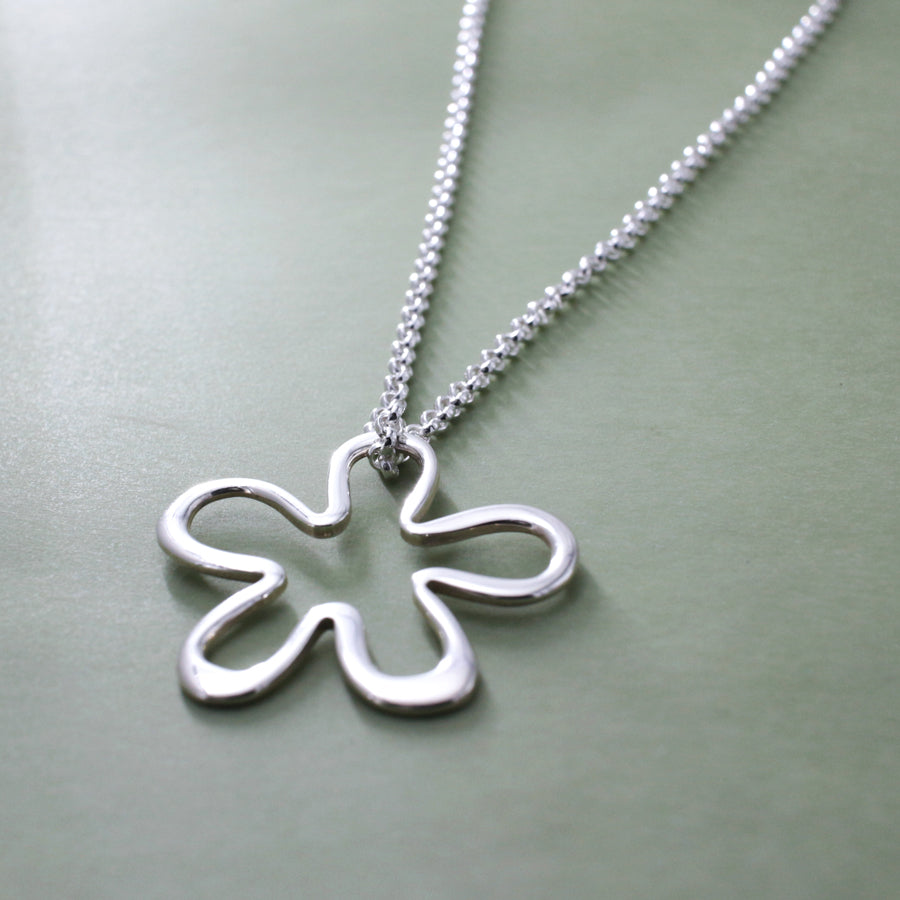 Moineir - Daisy Silhouette Silver Pendant Curated and designed by Emilio Sotelo Jewelry for Croi Kinsale Jewellery in Kinsale West Cork Ireland Europe. Find exceptional handmade silver and gold jewellery at affordable prices for birthday gifts and Christmas presents. Find Irish designers and makers. Beautiful jewellery shop located in Kinsale, Co. Cork.