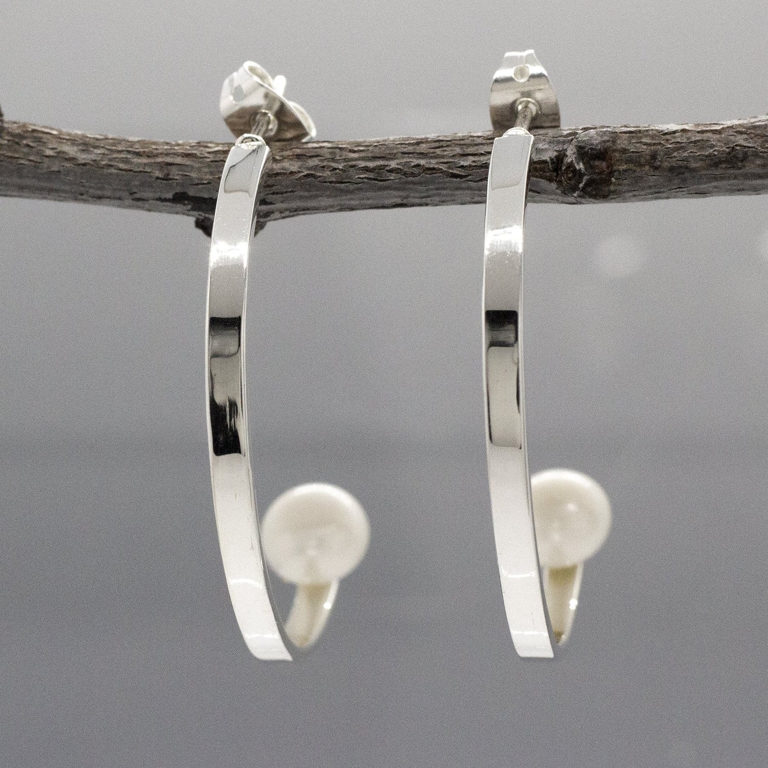 Artemis - Half Hoop Pearl Silver Earrings - Stud Curated and designed by Emilio Sotelo Jewelry for Croi Kinsale Jewellery in Kinsale West Cork Ireland Europe. Find exceptional handmade silver and gold jewellery at affordable prices for birthday gifts and Christmas presents. Handcrafted Silver jewelry. Find the best affordable jewellery
