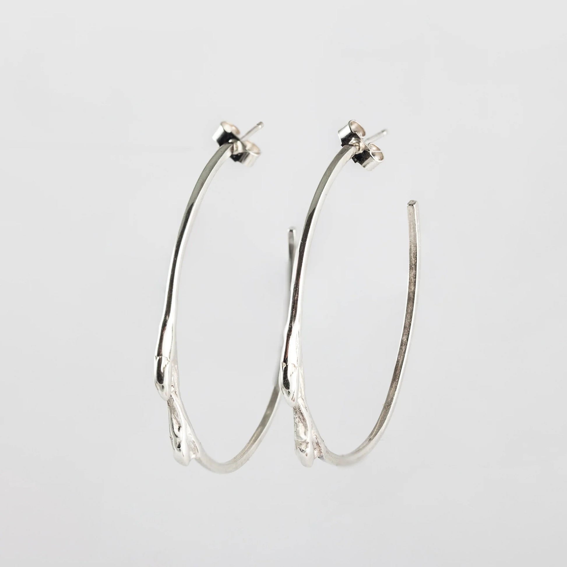 Material: Sterling silver Dimensions: 2.5mm at its widest point, 45mm in diameter Design: Sterling silver cast from twig with a highly polished finish Closure: Friction post Elegant and nature-inspired. Simple Twig Silver Hoop Earrings Kathleen Holland Jewellery