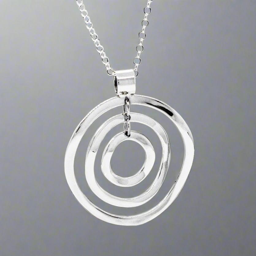 A striking symbol of timeless elegance, the&nbsp;AYA Multi Circle Silver Pendant is designed to complement any outfit with its sleek, versatile design. Its substantial size and refined craftsmanship make it a standout piece for both daily wear and special occasions.