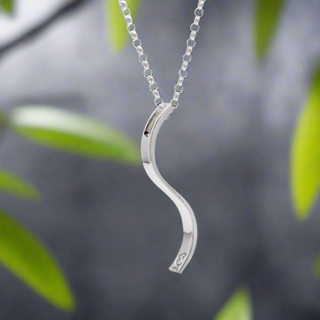 Sleek and sophisticated, the&nbsp;AYA S Bar Silver Pendant showcases a minimalist design with a contemporary edge. Crafted in .950 sterling silver, its three-dimensional form and high-polished finish make it a versatile piece for any jewellery collection.