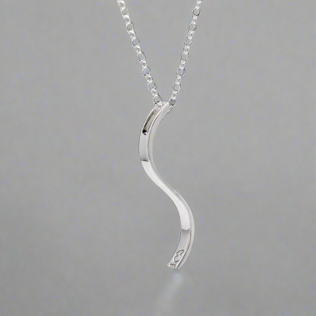 Sleek and sophisticated, the&nbsp;AYA S Bar Silver Pendant showcases a minimalist design with a contemporary edge. Crafted in .950 sterling silver, its three-dimensional form and high-polished finish make it a versatile piece for any jewellery collection.