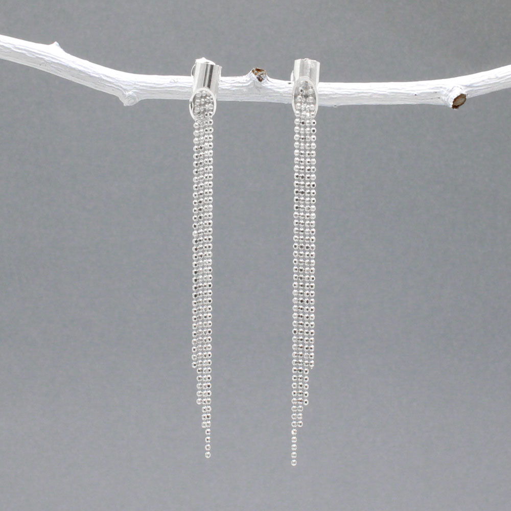 Áine - Cylinder with Chains Silver Earrings - Stud  Design: Four chains of different lengths cascading from the center of the cylinder Cylinder Diameter: 4 MM Total Length: 61 MM from top to bottom Material: Sterling silver with a highly polished finish Fastening: Sterling silver friction post