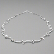 Áine Grace Silver Necklace is a perfect fusion of classic elegance and modern sophistication. Featuring delicately curved bar links accented with double 4 mm beads, this necklace is crafted in high-polished sterling silver to create a timeless, refined look. Ireland jewellry