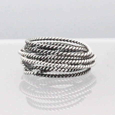 Aran - Twisted Lasso Oxidised Silver Ring. Inspired by the intricate twists of lasso rope designs, this piece adds a unique flair to your style.  Crafted from oxidised sterling silver and featuring a comfortable 7mm band width, it's ideal for wearing alone or stacking with other rings for a bold statement.&nbsp;