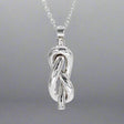 Aran - Single Open Knot Silver Pendant Ireland Jewellery West Cork

Inspired by timeless nautical knots. This sculpted pendant is handcrafted in solid sterling silver. Its open knot design, combined with a highly polished finish, makes it a versatile piece for daily wear or special occasions. Perfect Christmas Gift
Details:
* Material: Handmade solid sterling silver
* Dimensions: 12mm wide x 34mm high (from the top of the bail) x 8mm thick (approx. 1/2" x 1 3/8" x 5/16")