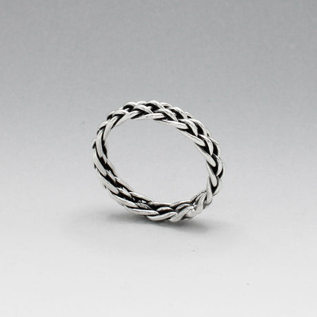 Aran - Thread Weave Oxidised Silver Ring  A unisex piece designed to seamlessly blend style and substance. This ring measures 5mm wide and 3mm thick, crafted from solid oxidised sterling silver.  Made with .925 sterling silver, the Aran ring offers both durability and timeless elegance. Its versatile design makes it a perfect accessory for any occasion, suitable for both men and women.
